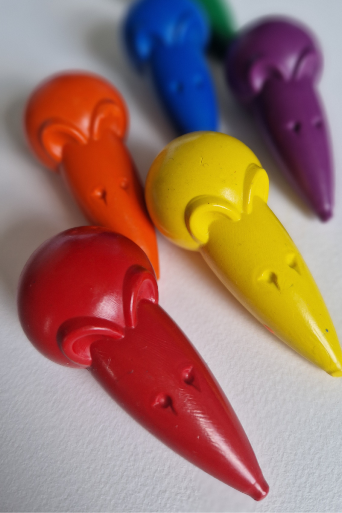 Colorful mouse-shaped palm-grip crayons designed for toddlers, with an ergonomic shape that fits naturally in a small child's whole hand